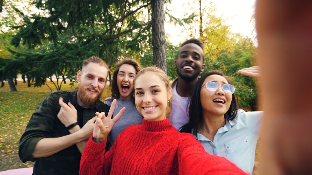 Young social media influencer taking a selfie outdoors